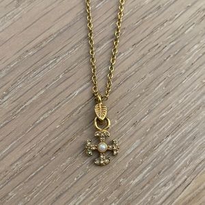 Small cross with pearl necklace.